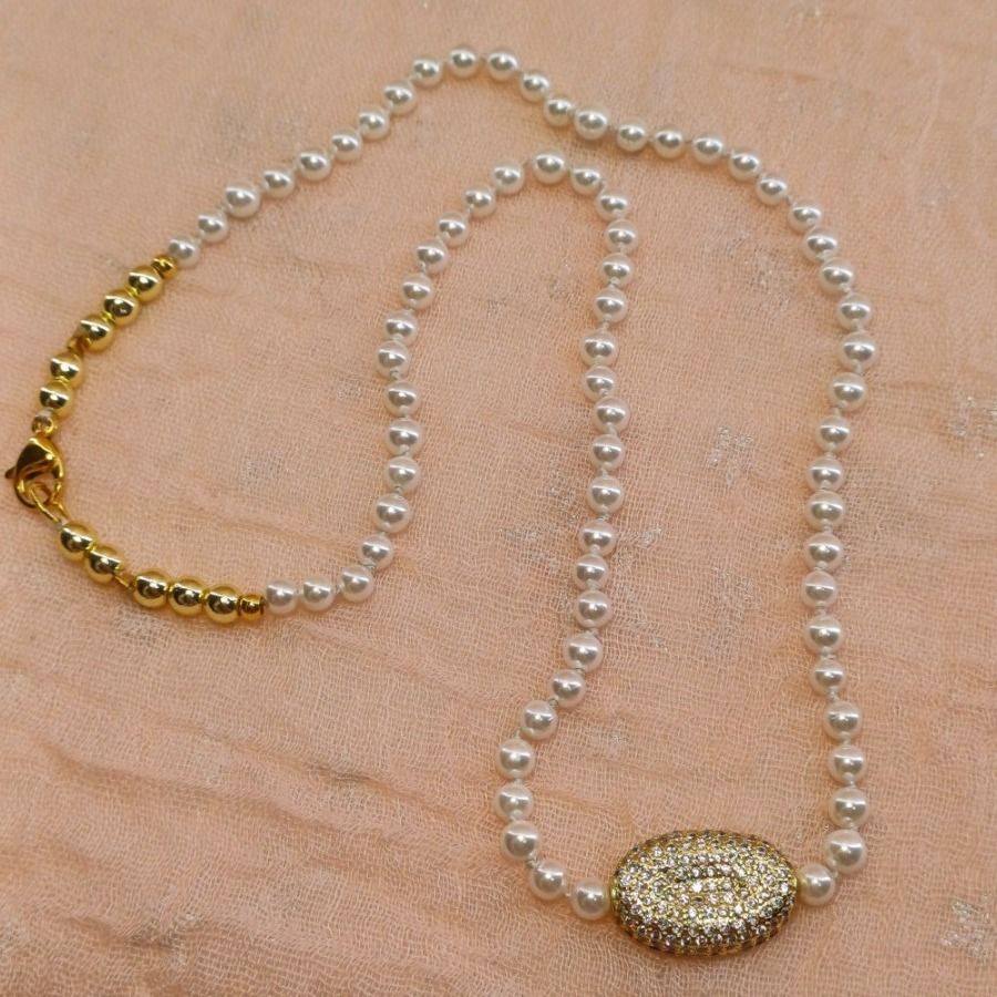Κολιέ με sell pearl ημιπολύτιμες πέτρες, χρυσούς αιματίτες και μοτίφ επίχρυσο με λευκά ζιργκόν.